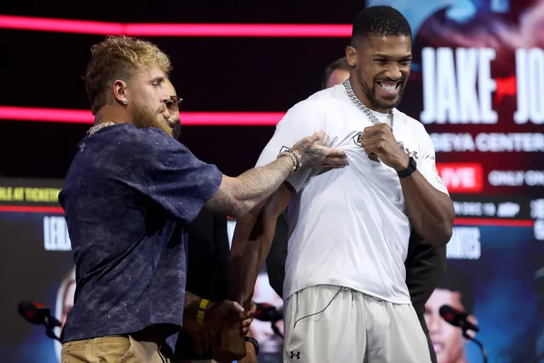 MIAMI, FLORIDA - DECEMBER 17: (L-R) Jake Paul and Anthony Joshua face off during the press conference at The Fillmore Miami Beach on December 17, 2025 in Miami Beach, Florida. Leonardo Fernandez/Getty Images/AFP