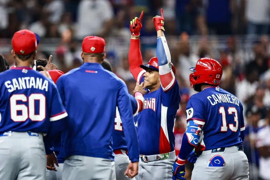Dominican Republic players celebrating after scoring against Venezuela.[AFP=Yonhap News]