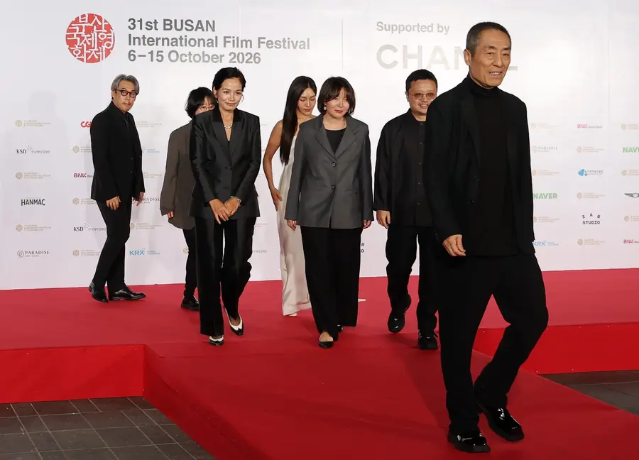 Director Zhang Yimou, right, chair of the competition jury at the 31st Busan International Film Festival closing ceremony, walks the red carpet with fellow jurors at the Busan Cinema Center in Haeundae-gu, Busan, on Oct. 15, 2026.